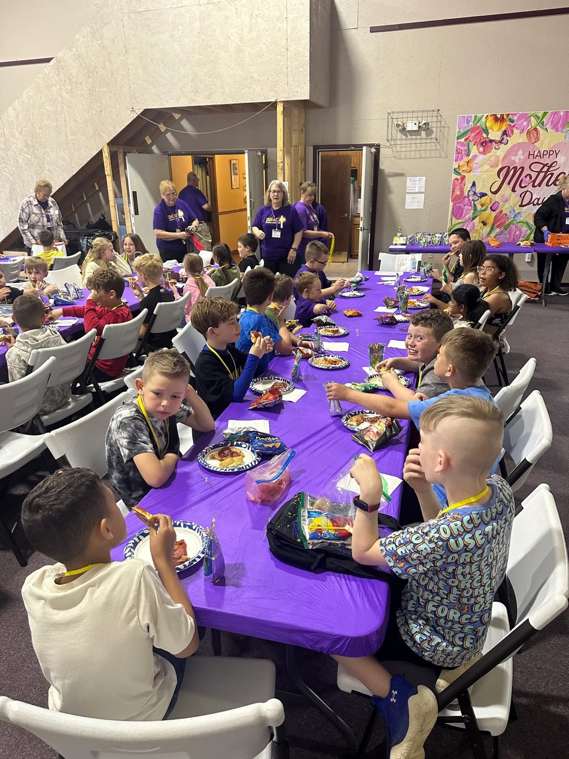 Students and volunteers at a meal